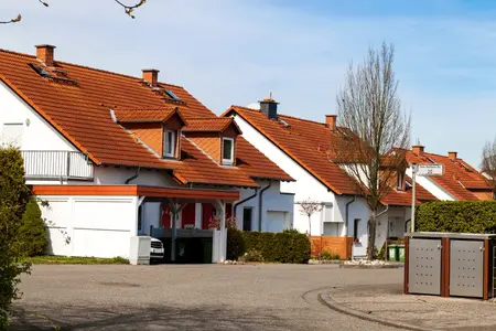 Rue résidentielle tranquille bordée de maisons blanches aux toits orange